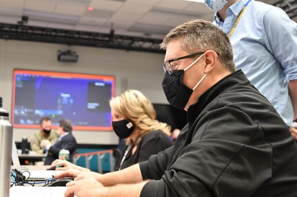 IMAGE: Bob Quinnan (right), a technical project manager, and Karen Smith, the deputy chief technology officer, both from Naval Surface Warfare Center Dahlgren Division (NSWCDD), play Simulated Practice Integrating New Technologies (SPRINT) during a wargaming event at NSWCDD’s Innovation Lab. SPRINT is a game which allows users to defend their designated ship using an array of weapons systems.
