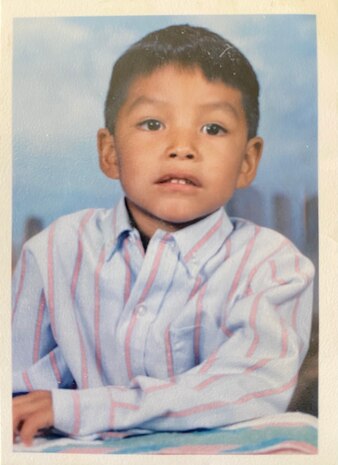 Airman 1st Class Verneon Reed, 319th Aircraft Maintenance Squadron Detachment 1 RQ-4 Global Hawk maintainer poses for a photo at his boarding school in 1992 in Arizona.