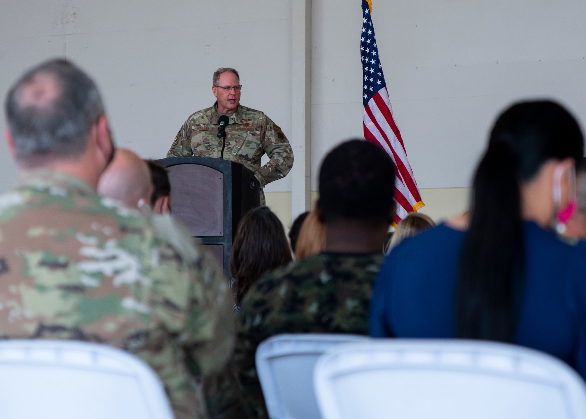 man gives a speech in front of a crowd.