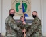 two men hold a guidon.