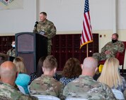 man gives a speech in front of a crowd.