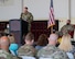 man gives a speech in front of a crowd.