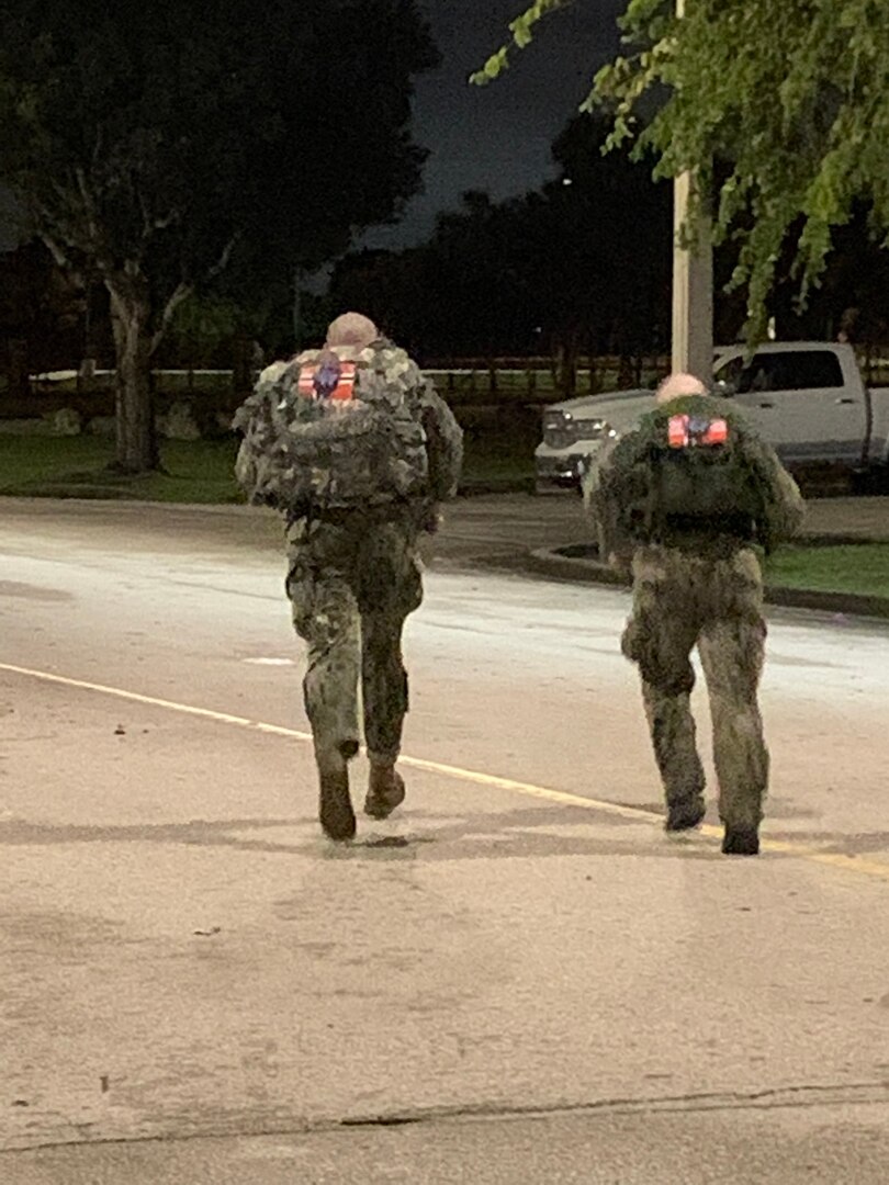 Two military participants run in the Norwegian Foot March at Homestead Air Reserve Base, Florida, on Nov. 19, 2021.