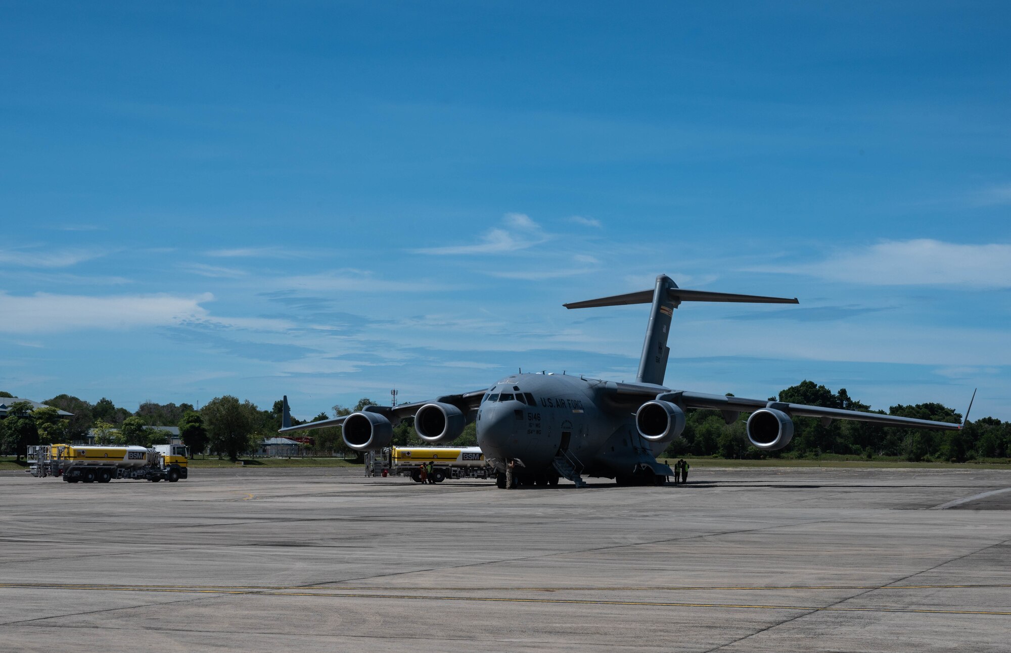 A C-17A Globemaster III assigned to Joint Base Pearl Harbor-Hickam, Hawaii, receives fuel from civilian contractors at Pusat Pergeraken Udara Air Movement Center, Brunei, Nov. 14, 2021. Exercises involving allied nations in the Indo-Pacific region strengthen relationships and enhance airframe interoperability. (U.S. Air Force photo by Staff Sgt. Alan Ricker)