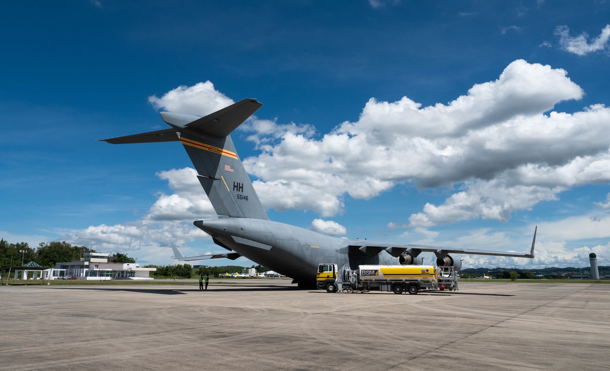 A C-17A Globemaster III assigned to Joint Base Pearl Harbor-Hickam, Hawaii, receives fuel from civilian contractors at Pusat Pergerakan Udara Air Movement Center, Brunei, Nov. 14, 2021. Exercises involving allied nations in the Indo-Pacific region strengthen relationships and enhance airframe interoperability. (U.S. Air Force photo by Senior Airman Alan Ricker)