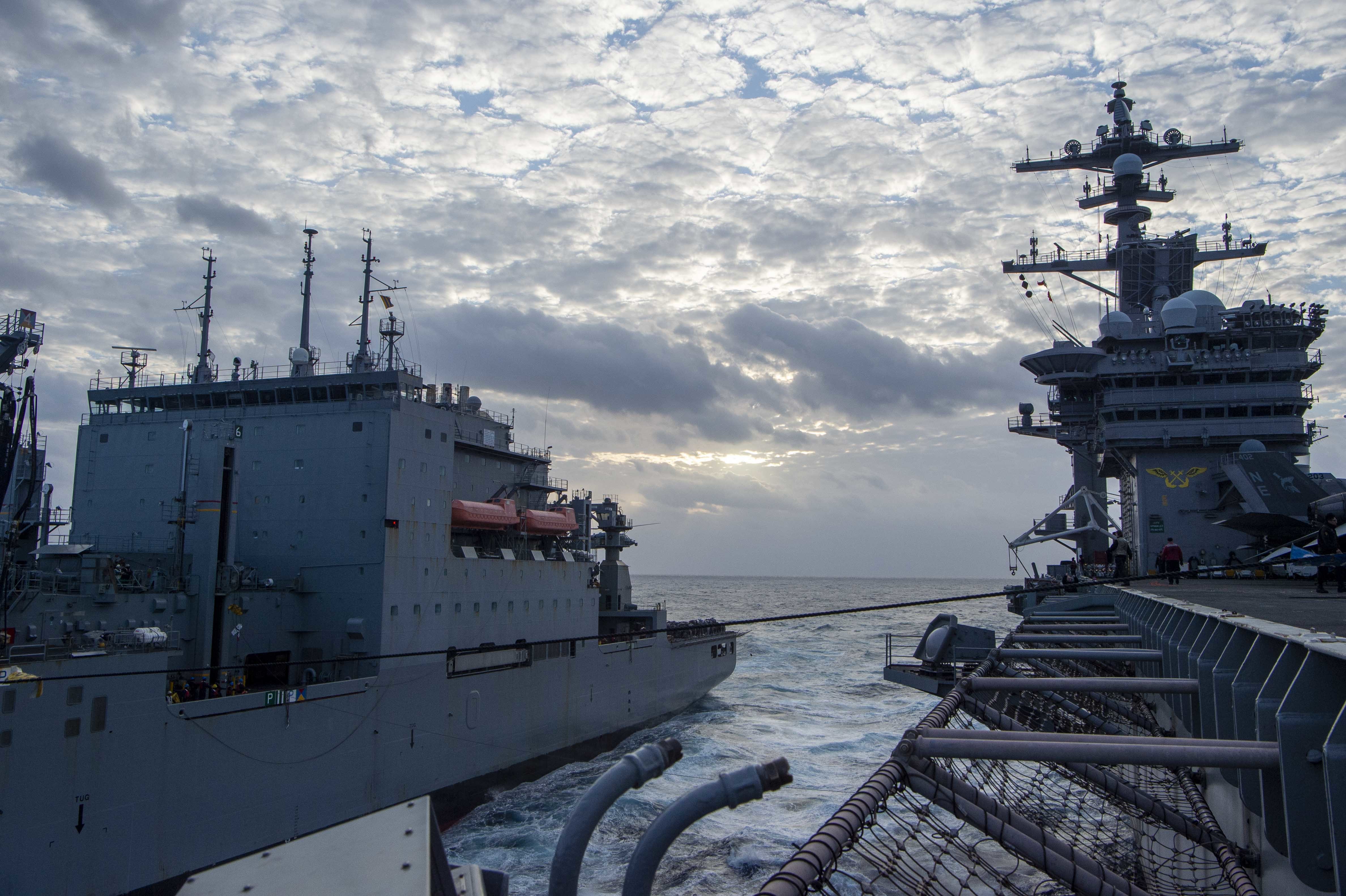 The Nimitz-class aircraft carrier USS Carl Vinson conducts a replenishment-at-sea with Lewis and Clark-class dry cargo ship USNS Matthew Perry (T-AKE 9), Nov. 23, 2021.