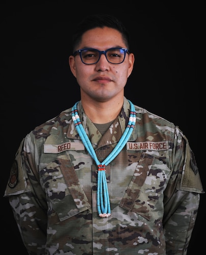 Airman 1st Class Verneon Reed, 319th Aircraft Maintenance Squadron Detachment 1 RQ-4 Global Hawk maintainer, poses for a photo, Nov. 17, 2021, at Beale Air Force Base, Calif. Reed is of the Navajo people, growing up on the Arizona side of the reservation. He poses with a traditional Navajo necklace worn by the tribes’ men.