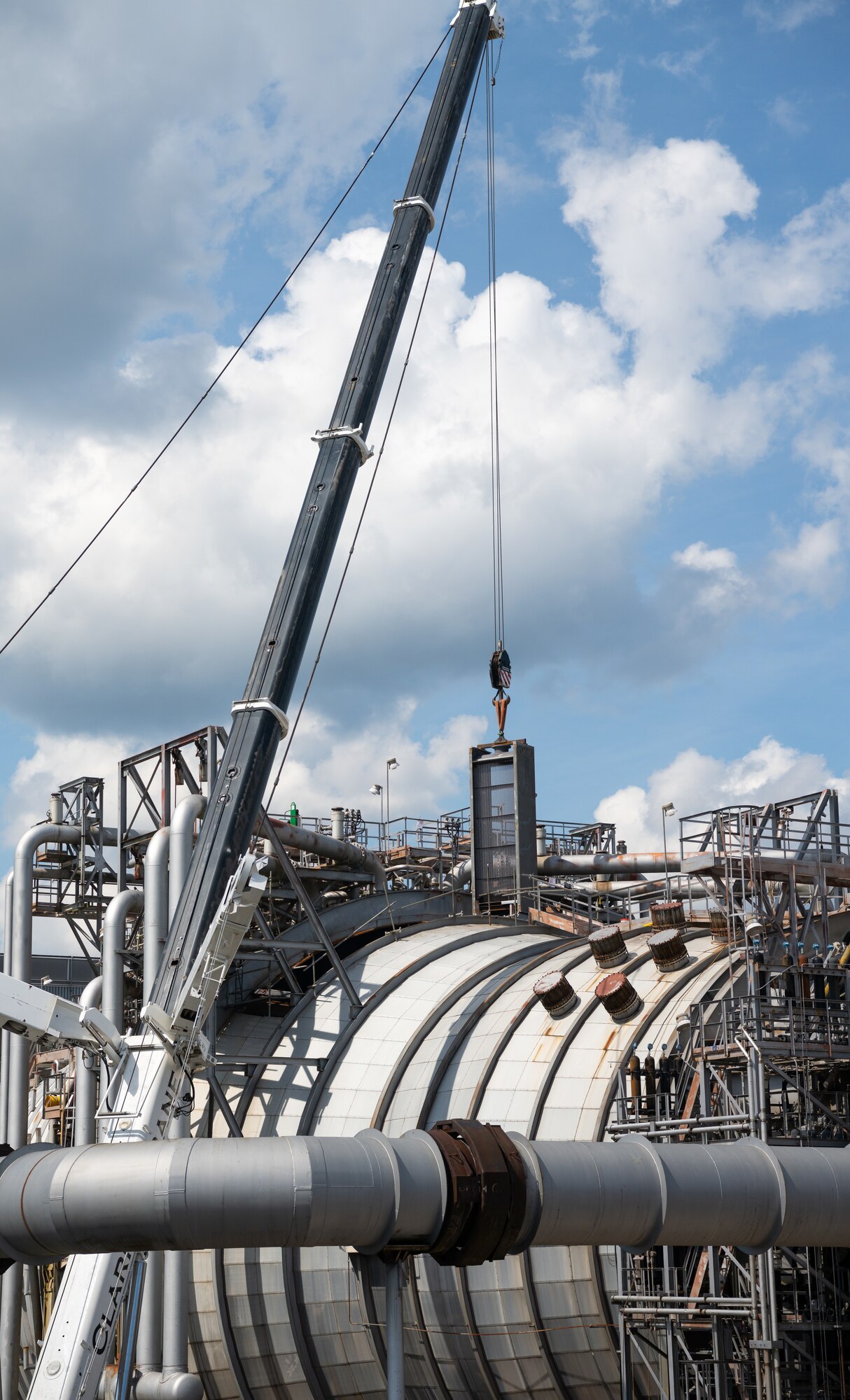 A heat exchanger is lifted and lowered into exhaust cooler 1 of the Aeropropulsion Systems Test Facility at Arnold Air Force Base, Tenn., Sept. 29, 2021. (U.S. Air Force photo by Jill Pickett)