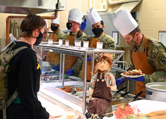 U.S. Army leaders serve a student during Thanksgiving at the Western Winds Dining Facility on Goodfellow Air Force Base, Texas, Nov. 25, 2021. Leadership from different squadrons and tenant units served food to show support for individuals who spent their Thanksgiving away from home. (U.S. Air Force photo by Senior Airman Ethan Sherwood)
