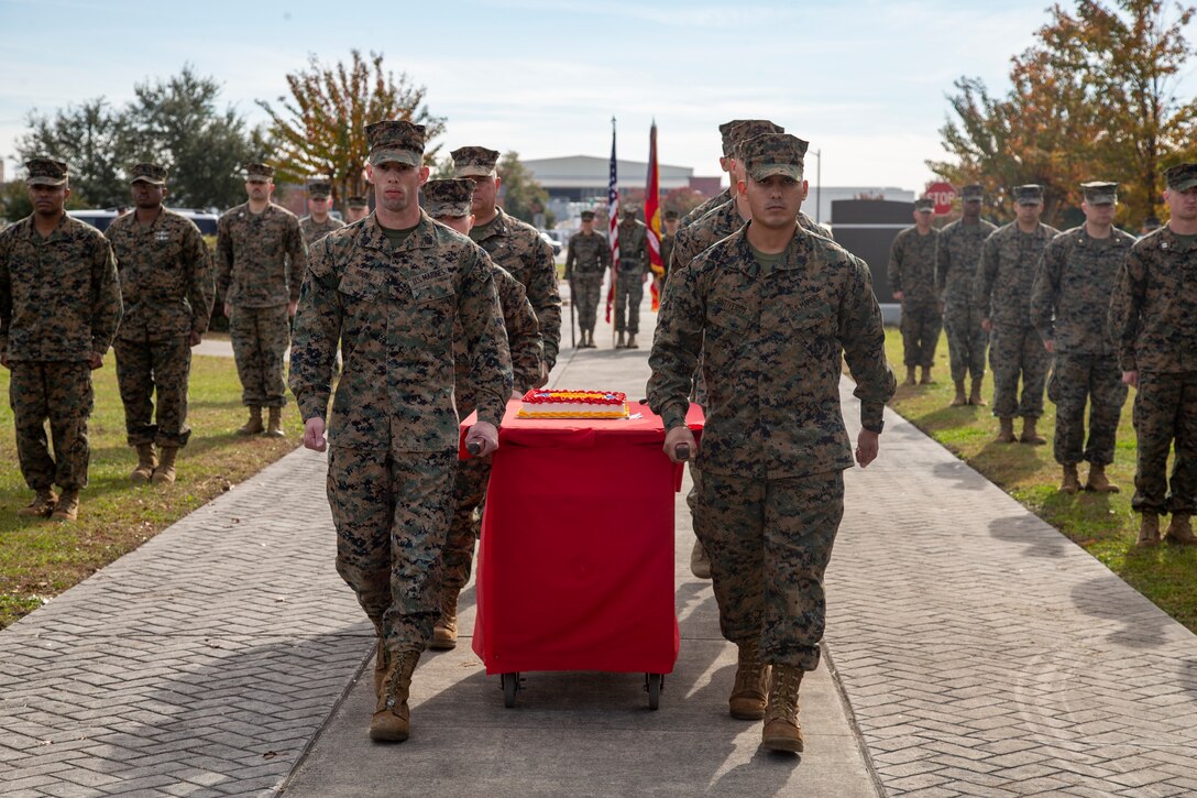 Marines with 2nd Marine Aircraft Wing march the cake during a cake-cutting ceremony honoring the Marine Corps’ 246th birthday at Marine Corps Air Station Cherry Point, North Carolina, Nov. 10, 2021. The ceremony is a time-honored tradition to celebrate the birth of the Marine Corps. (U.S. Marine Corps photo by Cpl. Yuritzy Gomez)