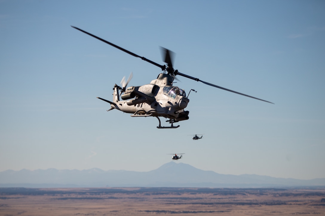 An AH-1Z Viper helicopter and two UH-1Y Venom helicopters assigned to Marine Light Attack Helicopter Squadron 269 fly over Lamar, Colorado, Nov. 12, 2021. Marines with HMLA-269 trained in a cold-weather, high-altitude environment to increase proficiency in expeditionary advanced basing operations. HMLA-269 is a subordinate unit of 2nd Marine Aircraft Wing, the aviation combat element of II Marine Expeditionary Force.