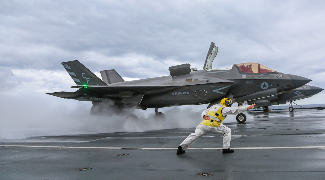 MEDITERRANEAN SEA (Nov. 24, 2021) A U.S. Marine with Marine Fighter Attack Squadron (VMFA) 211 accelerates an F-35B Lightning II on the flight deck of the Royal Navy aircraft carrier HMS Queen Elizabeth (R 08) in the Mediterranean Sea on November 24, 2021. VMFA-211 aircraft landed at Naval Station Rota as the first stop on their redeployment to Marine Corps Air Station Yuma, Ariz. The success of this deployment demonstrates that the United States and the United Kingdom are united in our efforts to ensure security and freedom of the seas, that our maritime power projection capabilities are interoperable, complementary, and global. (U.S. Marine Corps photo by 1st Lt. Zachary Bodner)