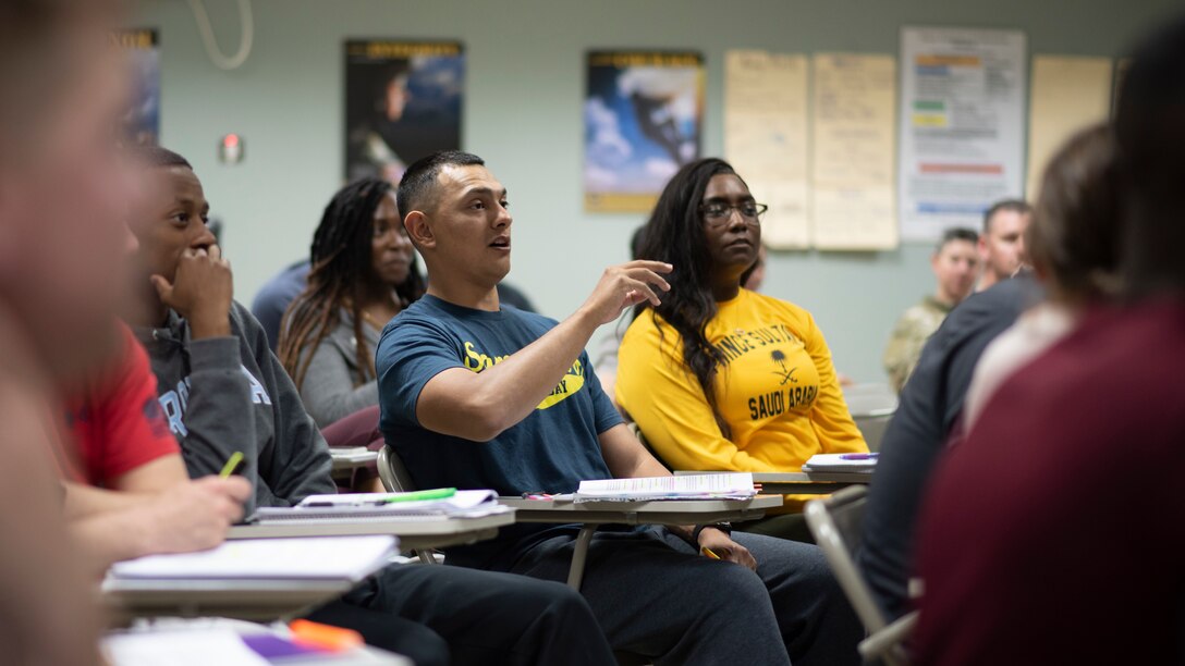 An Army student raises his hand during an annual equal opportunity leader course at Camp Buehring, Kuwait, November 9, 2021. This was an annual course required to certify Army military EO leaders. (U.S. Air Force photo by Staff Sgt. Ryan Brooks)