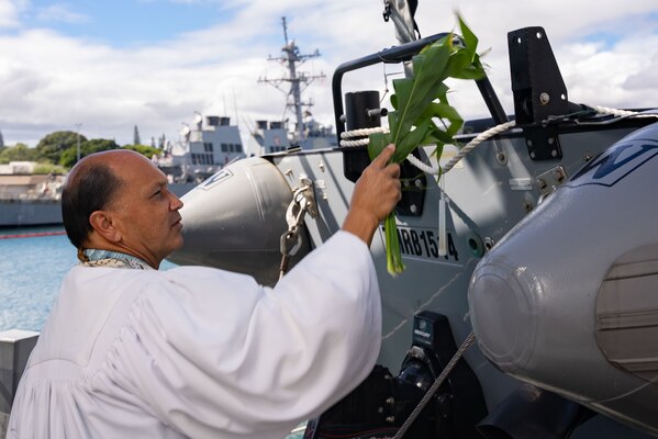 Kordell Kekoa, a Kahu or Hawaiian pastor, performs a Hawaiian blessing on a rigid-hull inflatable boat aboard the Navy's newest guided-missile destroyer, the future USS Daniel Inouye (DDG 118).