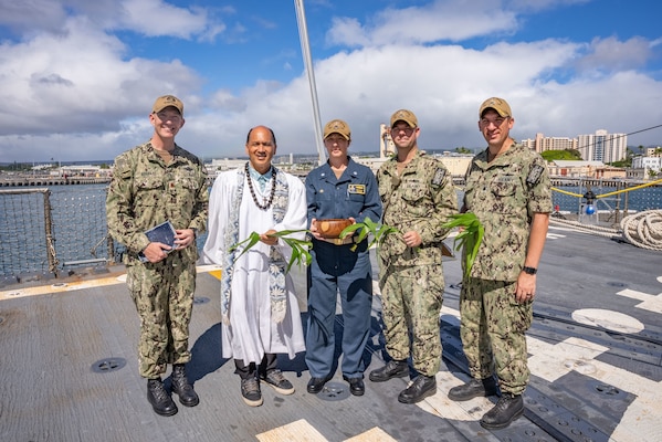 Kordell Kekoa, a Kahu or Hawaiian pastor, poses for a photo with Sailors aboard the Navy's newest guided-missile destroyer, the future USS Daniel Inouye (DDG 118) during a Hawaiian blessing ceremony.