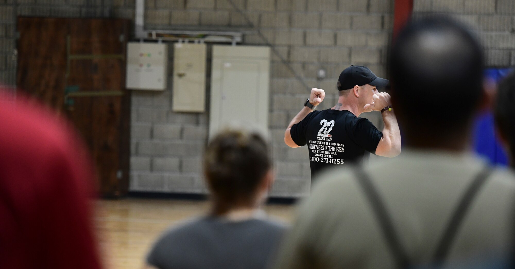 Man speaks to crowd during base event.