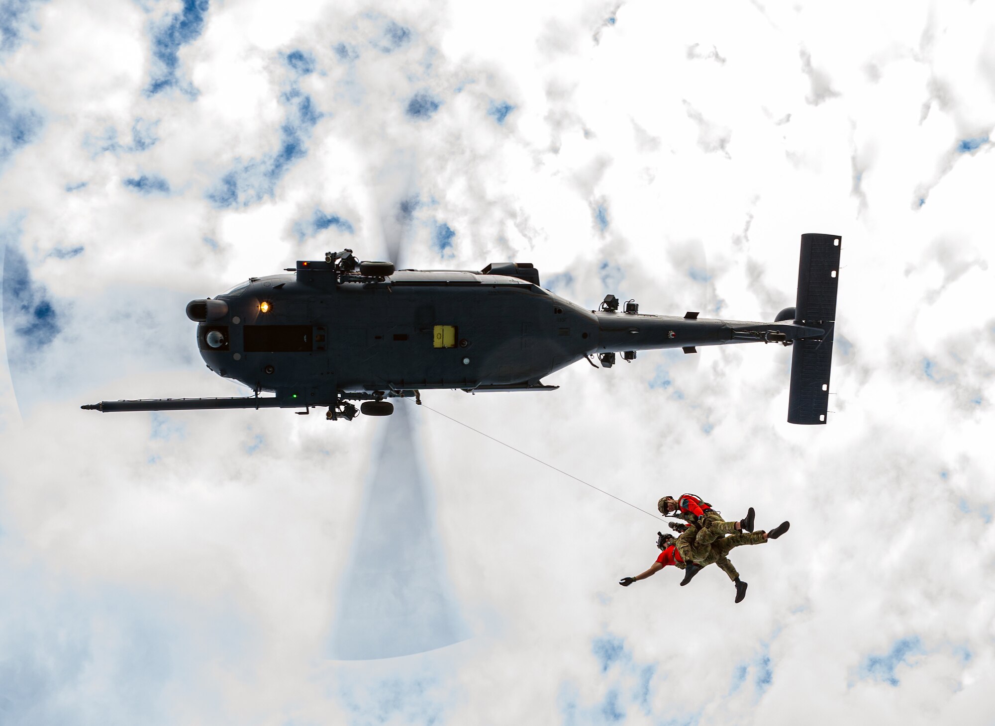 Pararescuemen conduct hoist operations in a HH-60G Pavehawk,