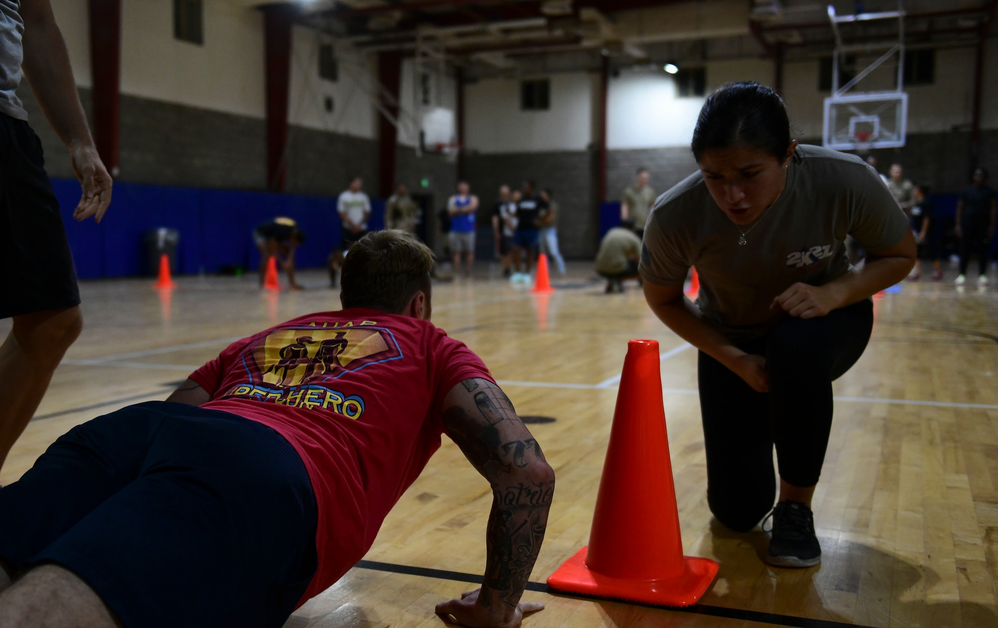 Airman counts her wingman's pushups during fitness event.
