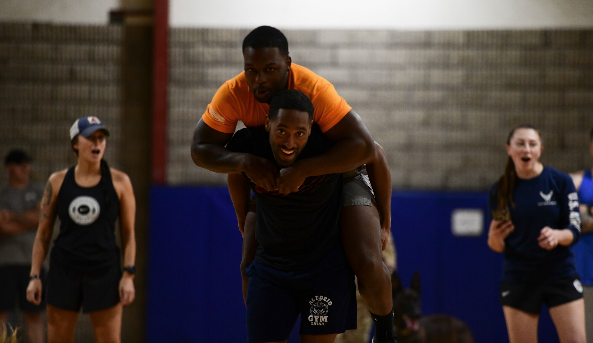Airman carries his wingman during fitness event.