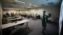 Lt. Cdr. Anthony Despota, the operations and logistics officer assigned to Joint Task Force Civil Support Incident Support Team 3, presents an operational overview as part of a joint reception, staging, onward movement, and integration brief at Hennepin Healthcare during the COVID-19 response operations in Minneapolis.