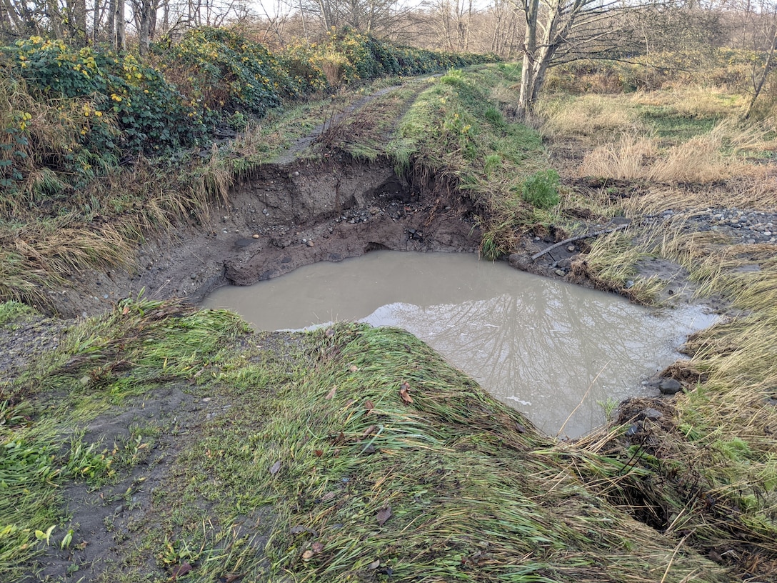 Water flowing through a breach in Rainbow Slough levee