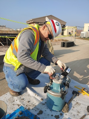 Glenn Sacro, a Far East District Kunsan Resident Office quality assurance representative, conducts concrete field testing during construction of project HAS 4-6 (2019UMMA031), a host-nation funded project that will construct 18 new Hardened Aircraft Shelters, along with taxi lanes and hangar access aprons, Nov. 3.