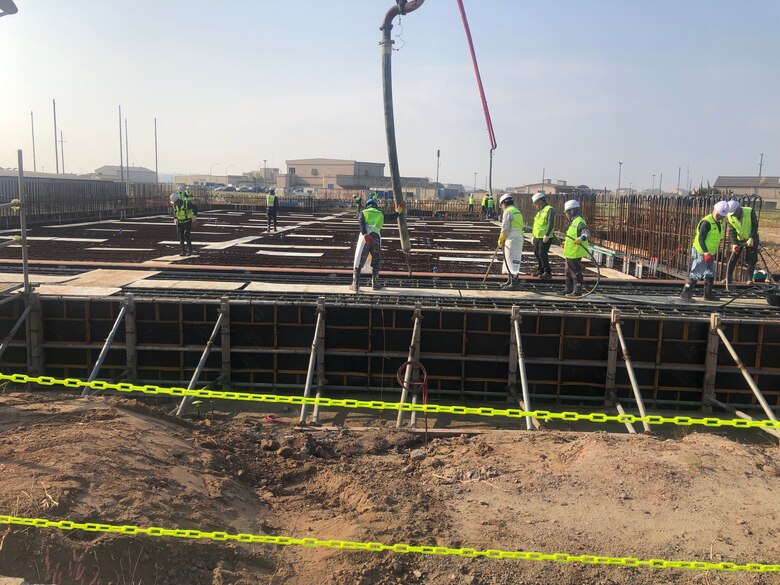 Contractors pour concrete for project HAS 4-6 (2019UMMA031), a host-nation funded project that will construct 18 new Hardened Aircraft Shelters, along with taxi lanes and hangar access aprons, Nov. 3.