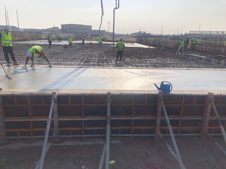 Contractors pour concrete for project HAS 4-6 (2019UMMA031), a host-nation funded project that will construct 18 new Hardened Aircraft Shelters, along with taxi lanes and hangar access aprons, Nov. 3.