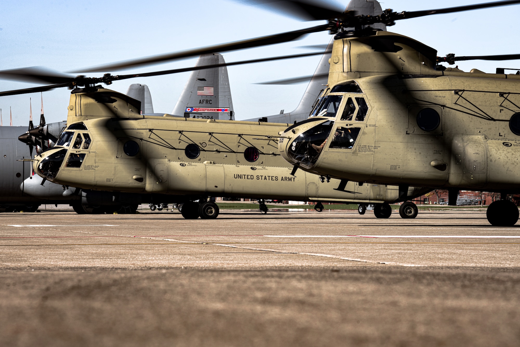 Two Ohio Army National Guard CH-46 Chinook helicopters prepare for takeoff from the Youngstown Air Reserve Station aircraft ramp after dropping off 910th Security Forces Squadron members.