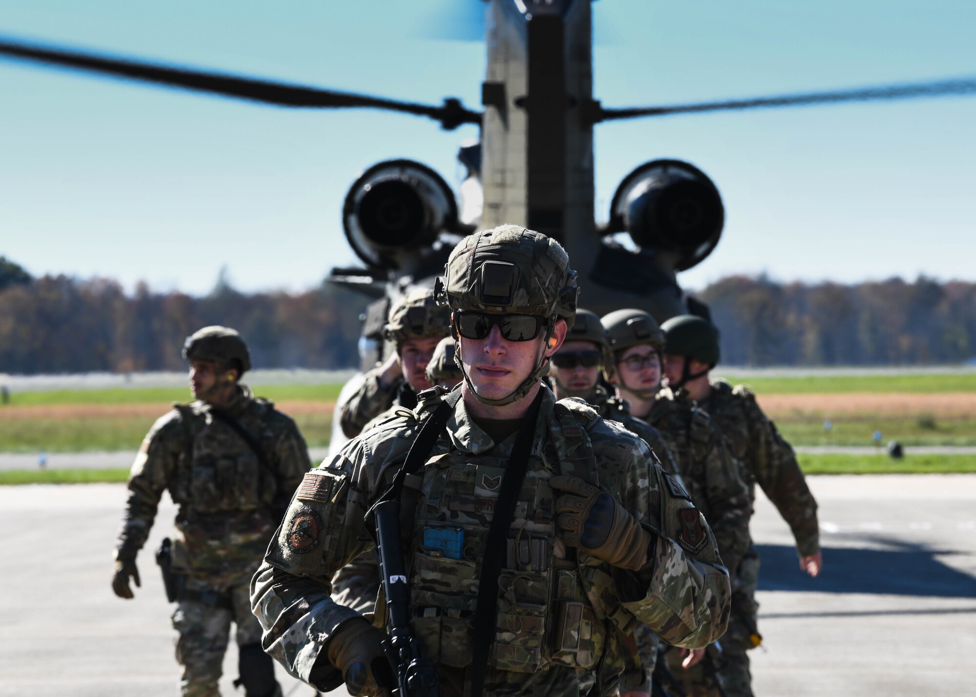 910th Security Forces Squadron members exit an Ohio Army National Guard CH-46 Chinook helicopter after combat training at Camp James A. Garfield Joint Military Training Center, Ohio, Nov. 6, 2021.