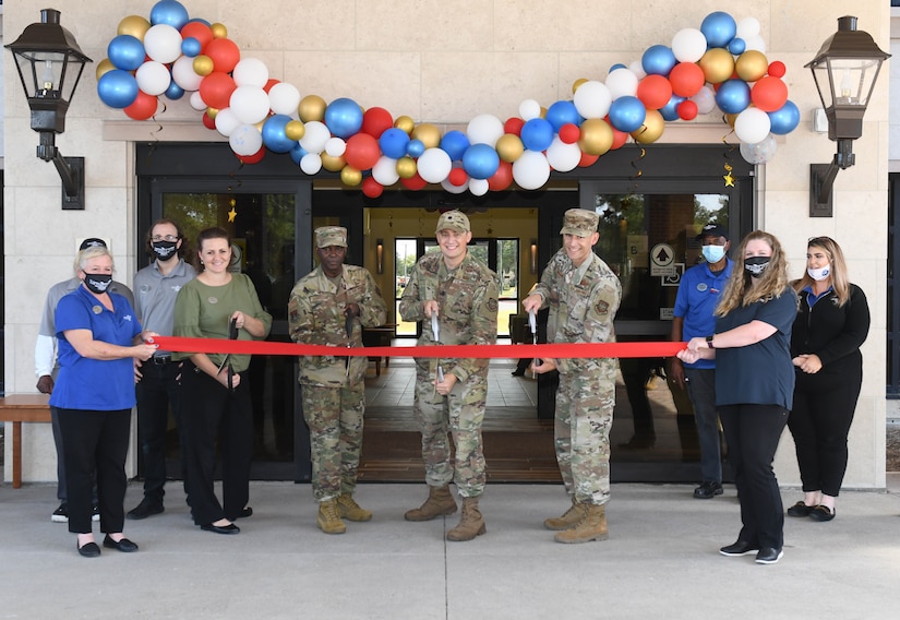 U.S. Air Force Lt. Col. Cody Gravitt, 628th Force Support Squadron commander, center, U.S. Air Force Col. Callistus Elbourne, 628th Mission Support Group command, left, U.S. Air Force Col. Marc Greene, 628th Air Base Wing and Joint Base Charleston commander and members of the 628th FSS cut the ceremonial ribbon in front of the Inns of Charleston at JB Charleston, Oct. 21, 2021.