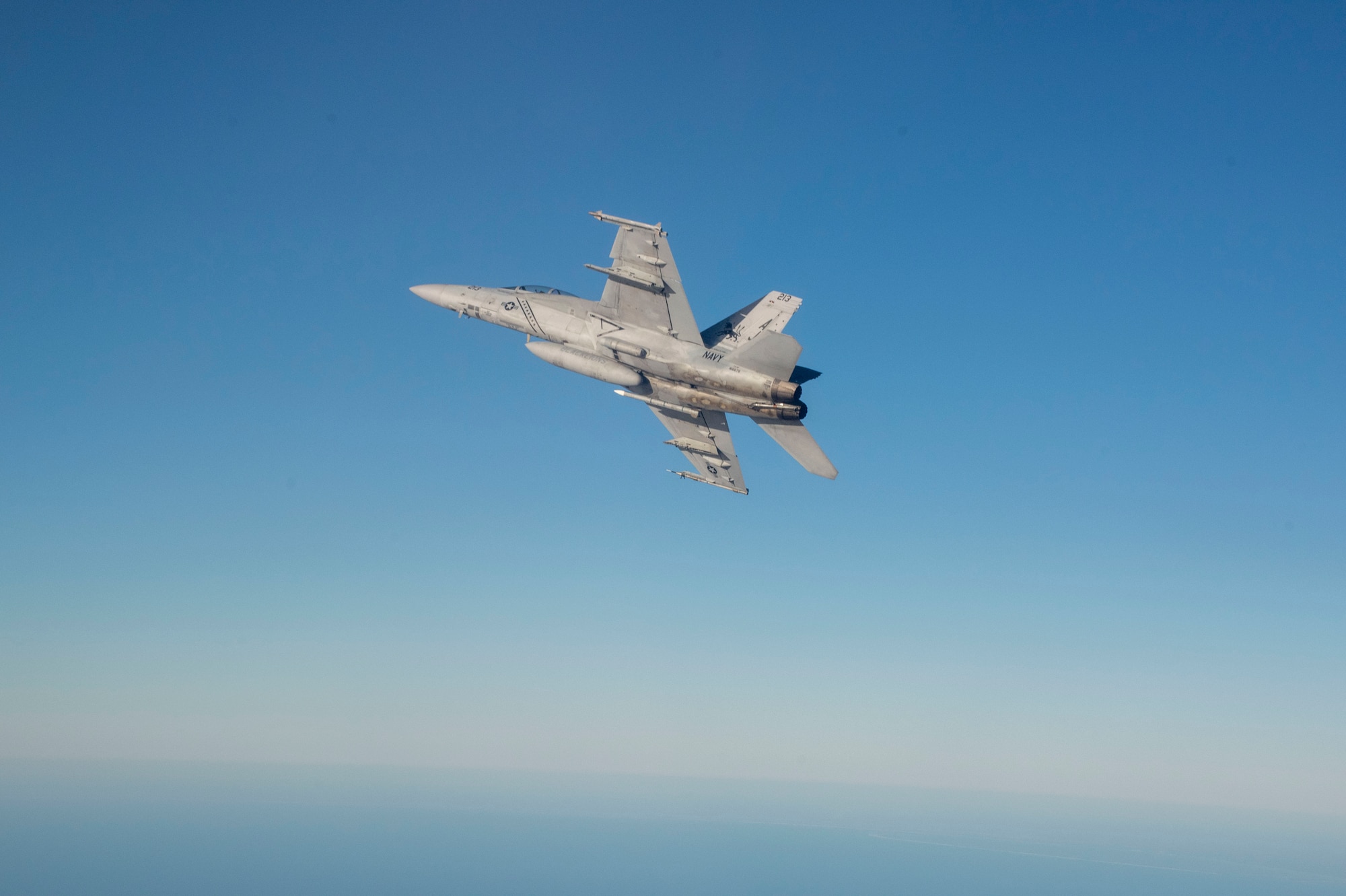 A U.S. Navy F/A-18F Super Hornet assigned to Naval Air Station Oceana, Virginia maneuvers while flying a sortie as part of the 53rd Weapons Evaluation Group’s Weapons System Evaluation Program East 22.02, hosted at Tyndall Air Force Base, Fla., Nov. 16, 2021. WSEP tests and validates the performance of crews, pilots, and their technology to enhance readiness for real-world operations. (U.S. Air Force photo by 1st Lt Lindsey Heflin)