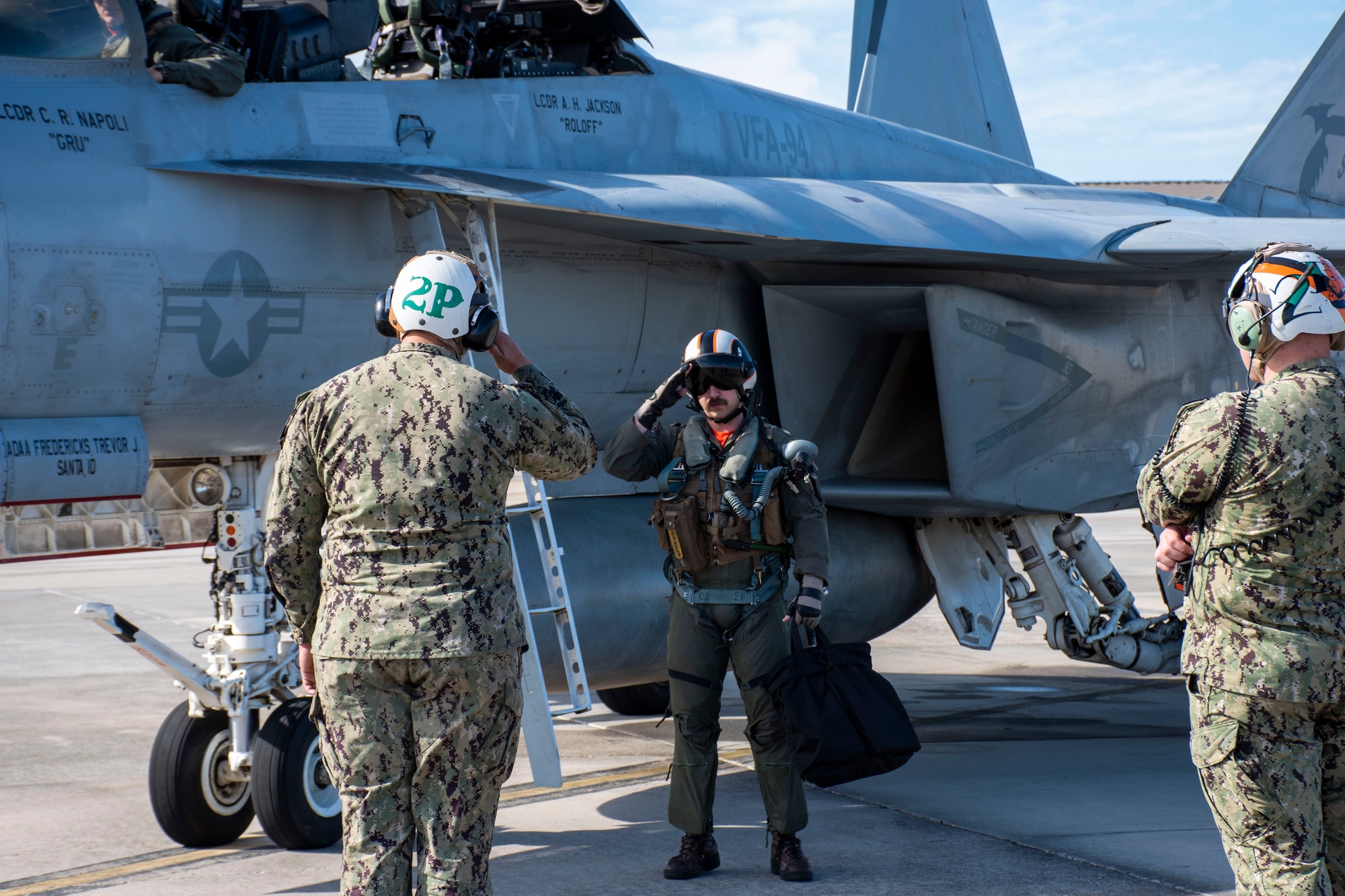 An F/A-18F Weapon Systems Operator attached to Strike Fighter Squadron 94 salutes his Plane Captain after returning from a Checkered Flag mission at Tyndall AFB, Fla., Nov. 10, 2021. WSEP which tests and validates the performance of crews, pilots, and their technology to enhance readiness for real-world operations. (U.S. Air Force photo by 1st Lt Lindsey Heflin)