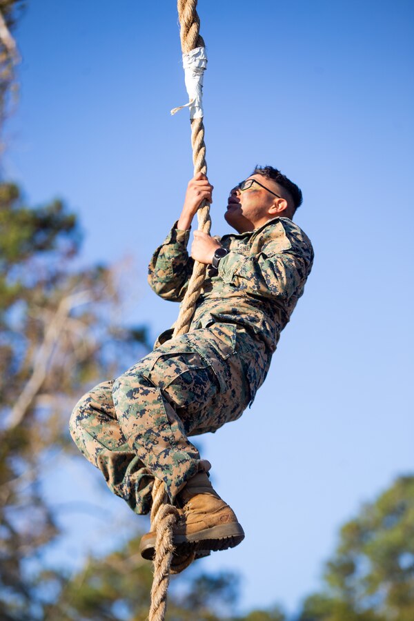 U.S. Marine Corps Cpl. Raul Yazzie, a native of Chinle, Ariz. and a radio operator with 2d Battalion, 2d Marine Regiment, 2d Marine Division, climbs a rope in commemoration of Tarawa Day on Camp Lejeune, N.C., Nov. 23, 2021.