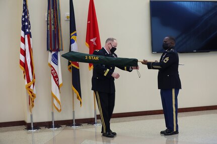 Maj. Gen. Mark E. Black, director of operations, J3 (Wartime) United States Forces Korea, uncases his new two-star flag during his promotion ceremony, November 16, 2021.  The ceremony took place at the Joint Atrium, Marshall Hall, Fort Bragg, N.C.