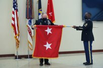 Maj. Gen. Mark E. Black, director of operations, J3 (Wartime) United States Forces Korea, inspects his new two-star flag during the uncasing at his promotion ceremony, November 16, 2021.  The ceremony took place at the Joint Atrium, Marshall Hall, Fort Bragg, N.C.