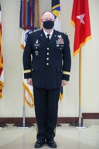 Maj. Gen. Mark E. Black, director of operations, J3 (Wartime) United States Forces Korea, stands for ceremonial honors during his promotion ceremony, November 16, 2021.  The playing of two sets of ruffles and flourishes designated his new two-star status during the ceremony at the Joint Atrium, Marshall Hall, Fort Bragg, N.C.