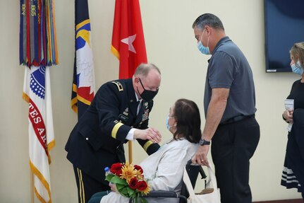 Maj. Gen. Mark E. Black, director of operations, J3 (Wartime) United States Forces Korea, presented his mother with a bouquet of flower to honor her continued support of him and his career during his promotion ceremony, November 16, 2021.  The ceremony took place at the Joint Atrium, Marshall Hall, Fort Bragg, N.C.