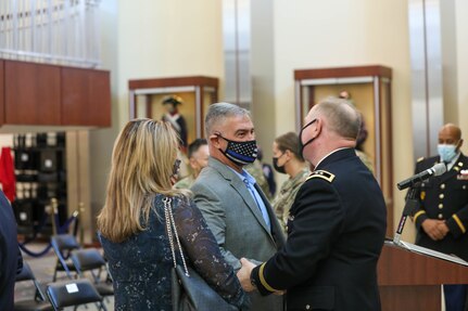 Retired Command Sgt. Maj. Robert J. Riti, who served with Maj. Gen. Mark E. Black at the 108th Training Command, IET, congratulated Black on his promotion following the ceremony, November 16, 2021 at the Joint Atrium, Marshall Hall, Fort Bragg, N.C.