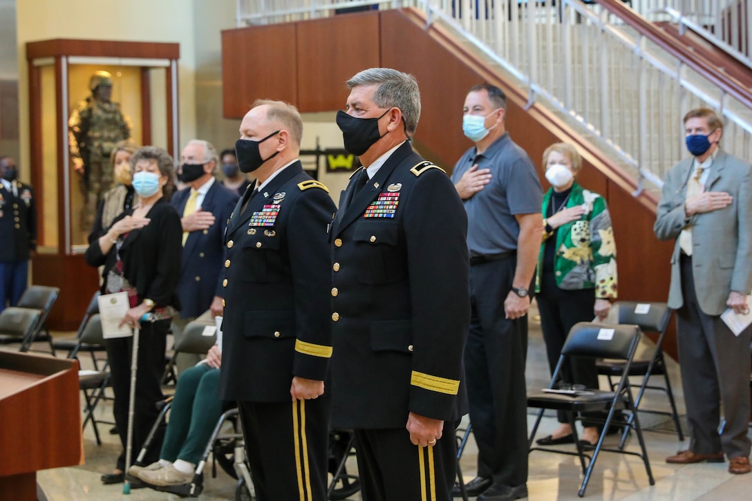 Retired Maj. Gen. Mark McQueen, former commanding general, 108th Training Command (IET), and Maj. Gen. Mark E. Black, director of operations, J3 (Wartime) United States Forces Korea, stand at attention during the playing of the National Anthem during Black’s promotion ceremony at the Joint Atrium, Marshall Hall, Fort Bragg, N.C., November 16, 2021,