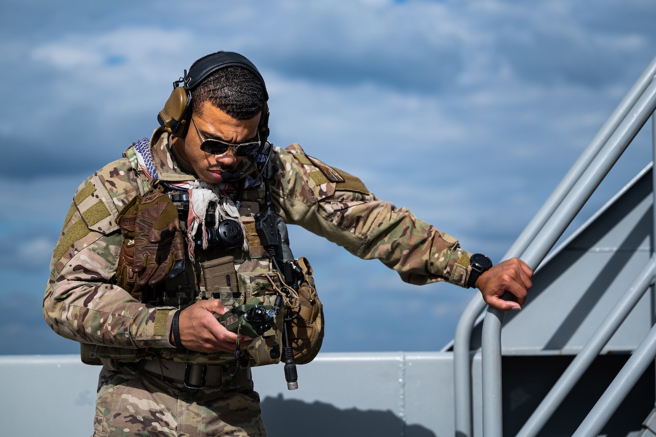 An airman uses an electronic device.