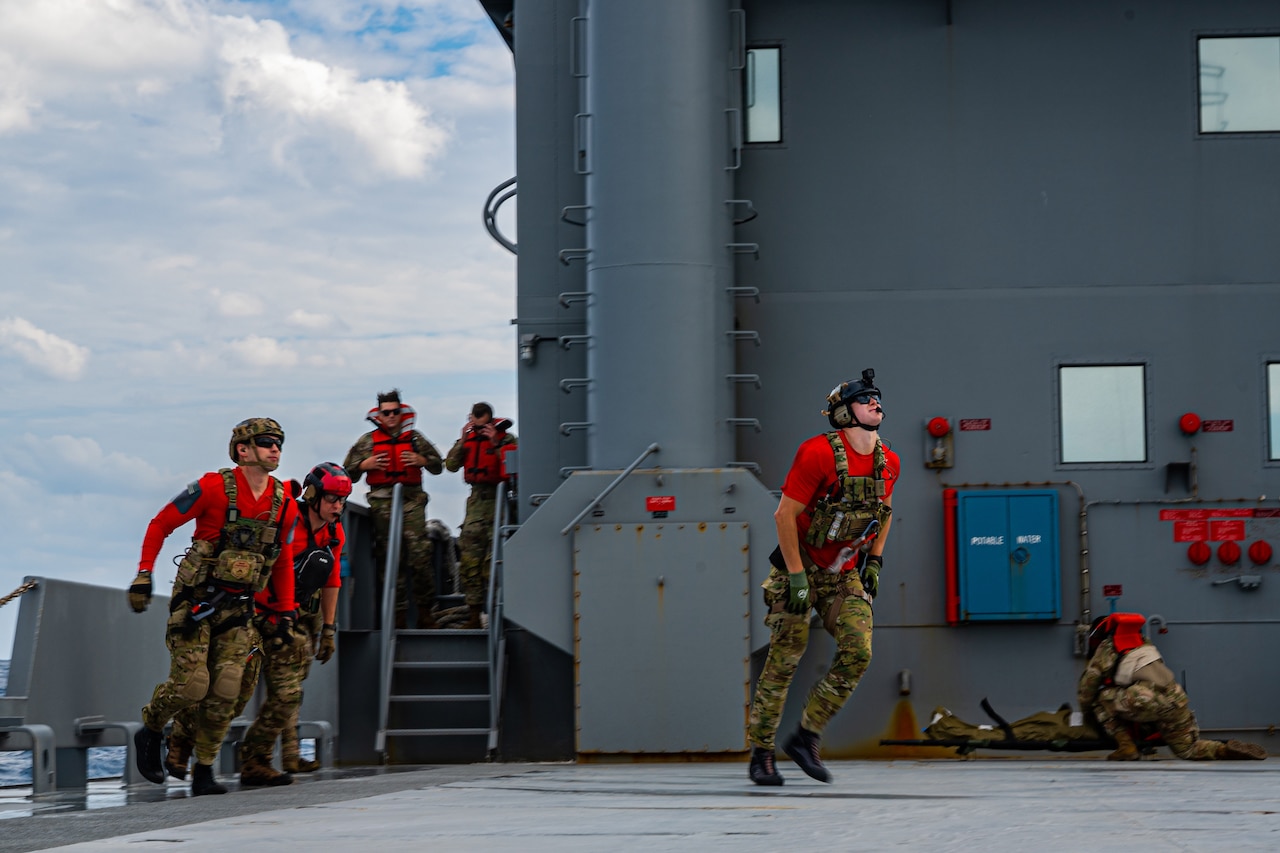 Service members conduct training on a ship.