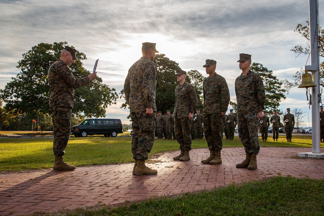 U.S. Marine Corps Sgt. Maj. Daniel L. Krause, left, a native of Jacksonville, N.C., and the division sergeant major of 2d Marine Division (MARDIV), Maj. Gen. Frank L. Donovan, the commanding general of 2d MARDIV, U.S. Navy Hospital Corpsman 1st Class Steven Tabisz, a native of Severna Park, Md., with the Division Surgeon's Office, Sgt. Dayveon Burns, a native of McDonough, Ga., and an intelligence specialist with 1st Battalion, 2d Marine Regiment, 2d MARDIV, and Lance Cpl. Mitchell Kautzer, a native of Whitelaw, Wis., and a motor vehicle operator with 2d Combat Engineer Battalion, 2d MARDIV, stand at attention at the quarterly morning colors ceremony on Camp Lejeune, N.C., Nov. 19, 2021. During the ceremony, Donovan presented awards for Marine of the Quarter, Non-Commissioned Officer of the Quarter, and Sailor of the Quarter. (U.S. Marine Corps photo by Lance Cpl. Brian Bolin Jr.)