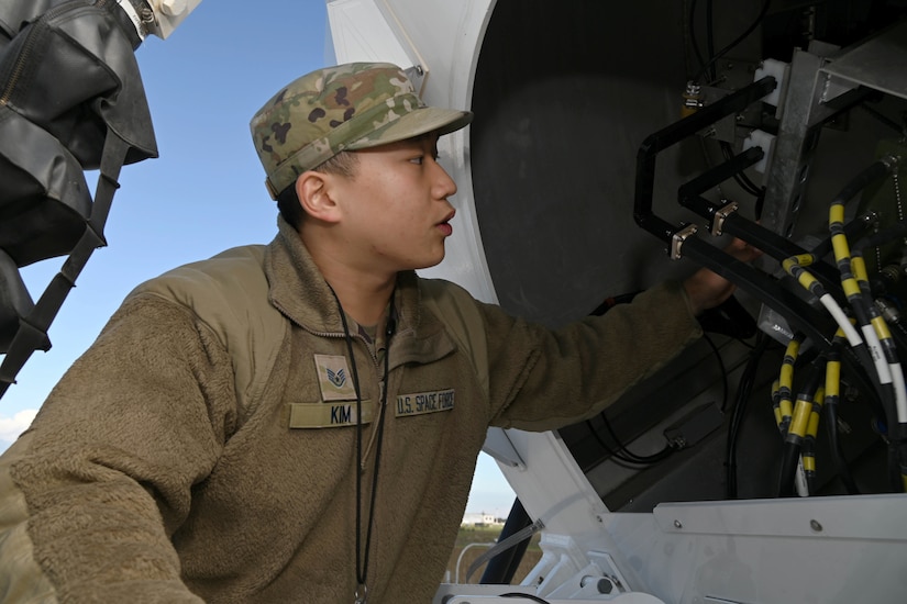 A guardian handles wiring in a satellite.