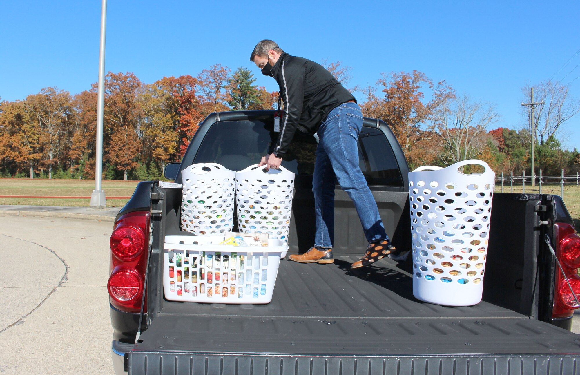 A member of the Arnold Junior Force Council Booster Club loads baskets of food donations Nov. 19, 2021, at Arnold Air Force Base, Tenn., part of the Thanksgiving Basket Food Program.
