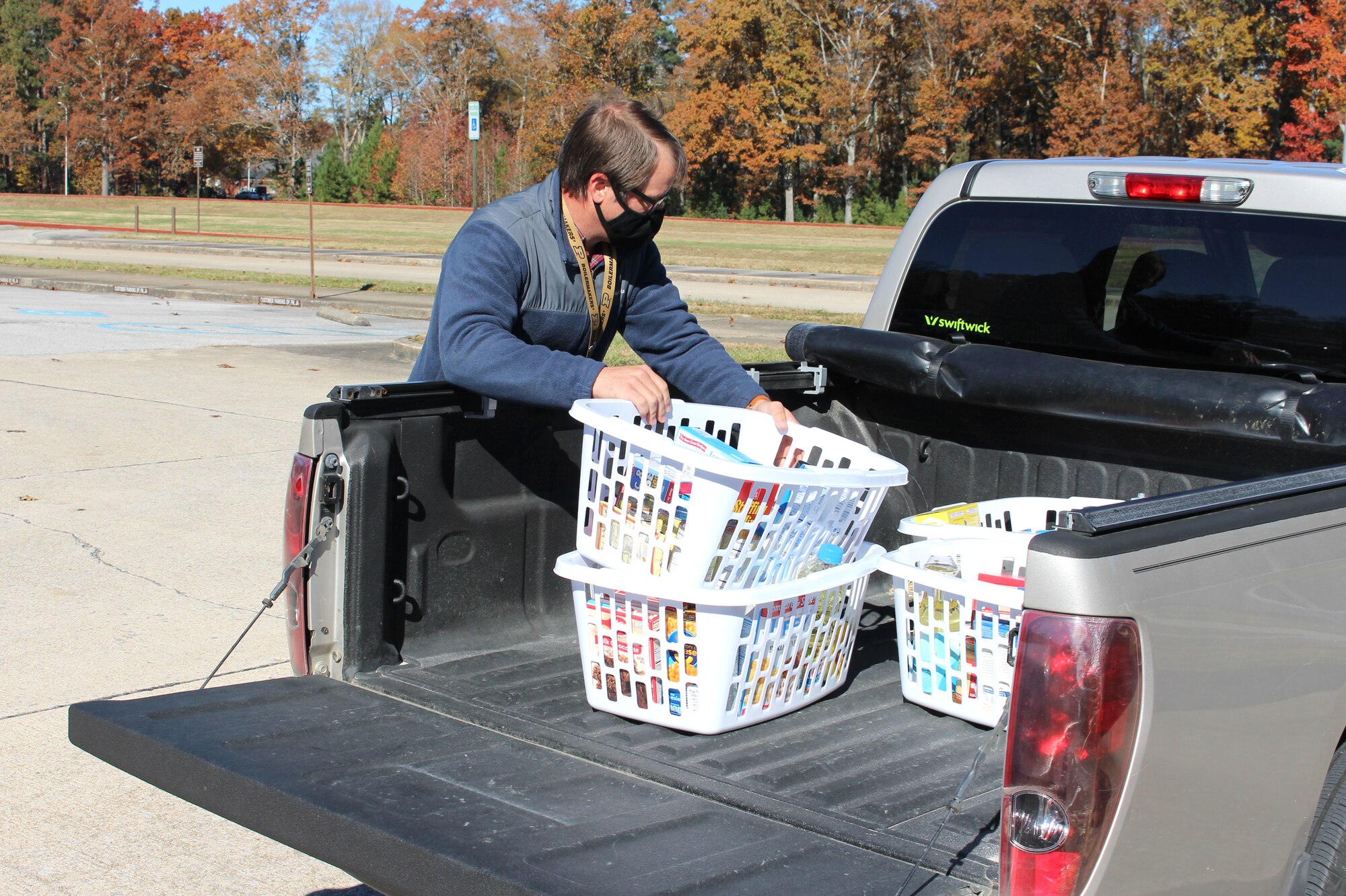 An AEDC team member assists with loading food baskets into his truck Nov. 19, 2021, at Arnold Air Force Base, Tenn.