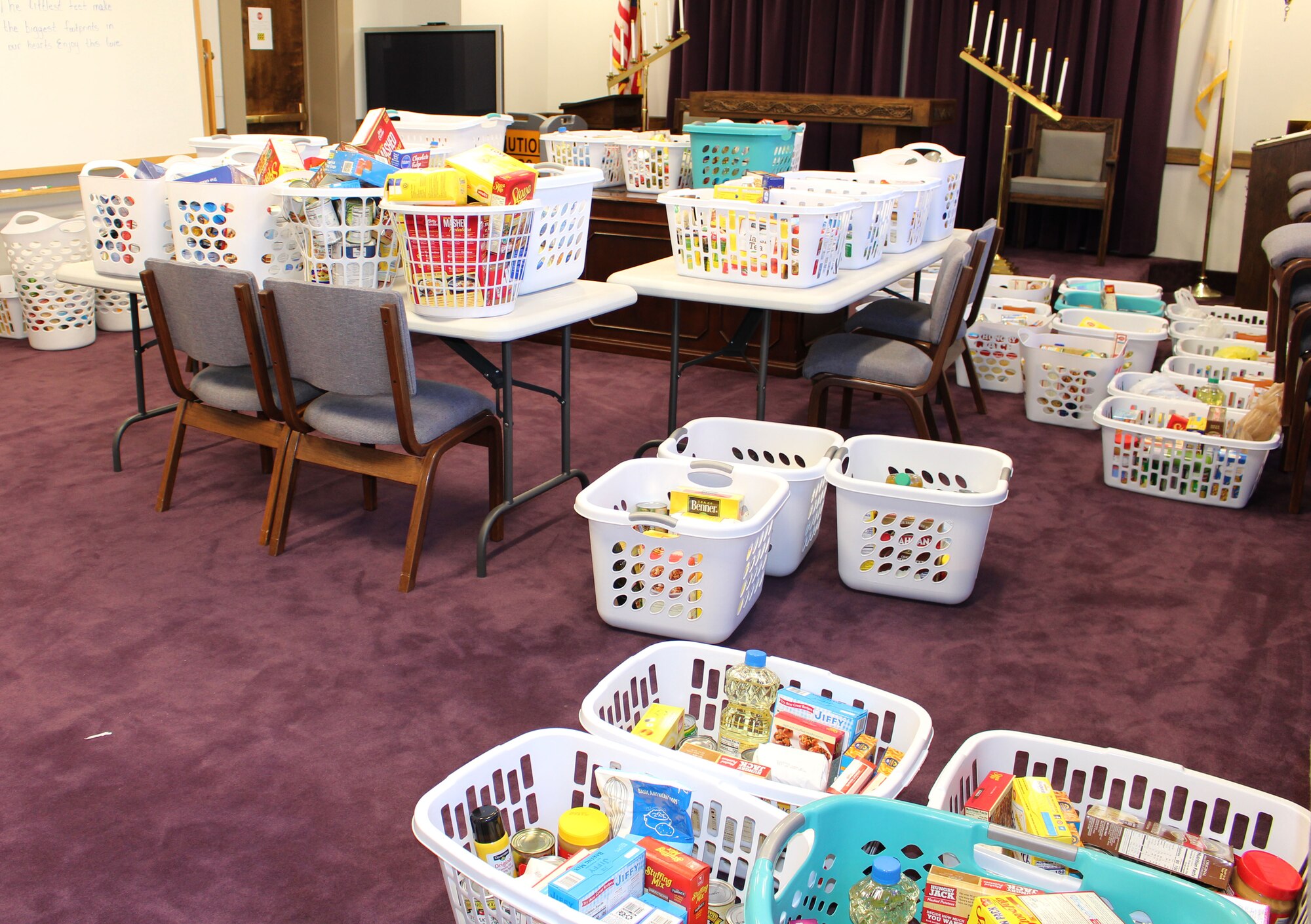 A large number of food baskets collected by the Junior Force Council Booster Club sit in the chapel at Arnold Air Force Base, Nov. 19, 2021. A total of 62 baskets were collected.