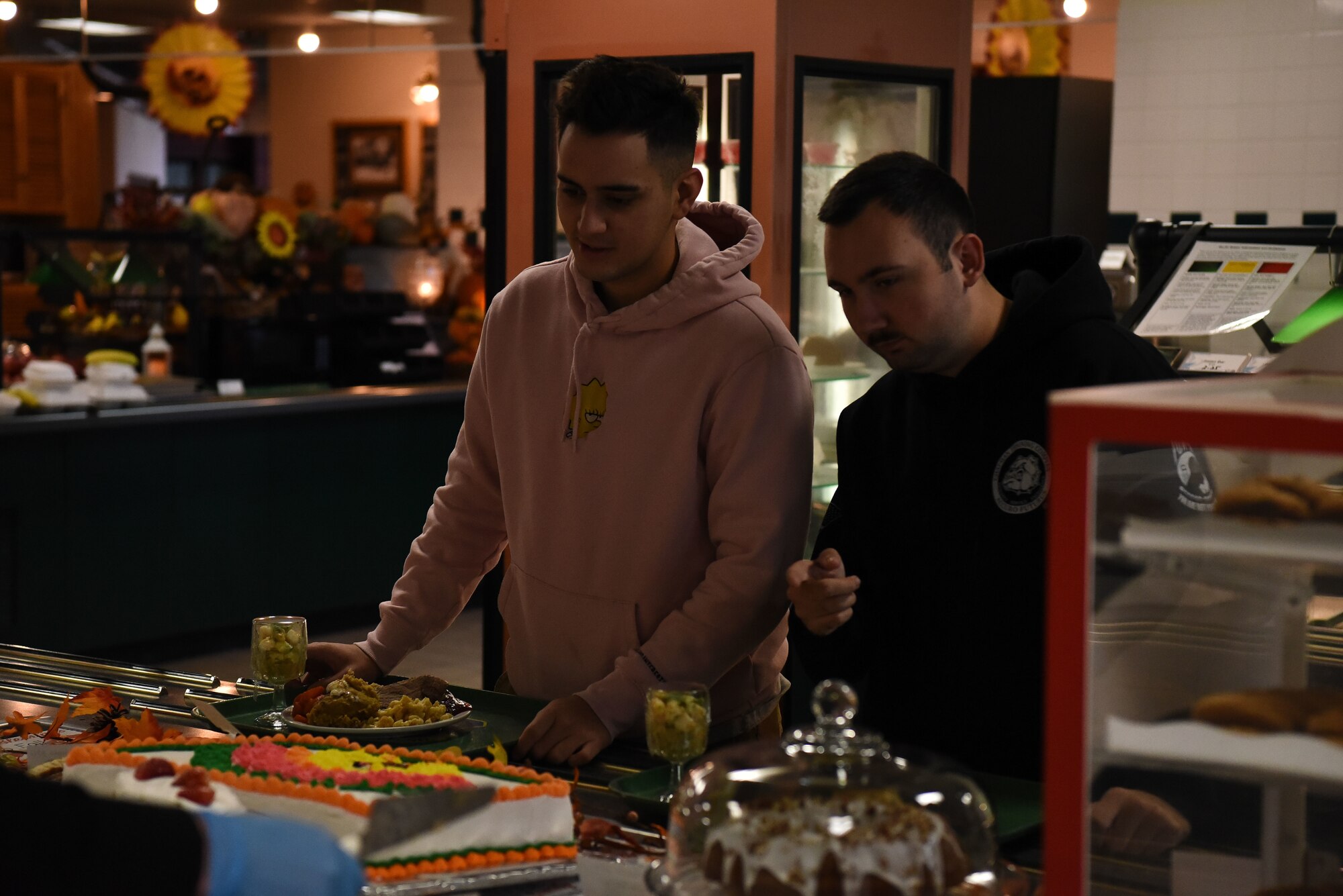 Two military members choose a dessert.