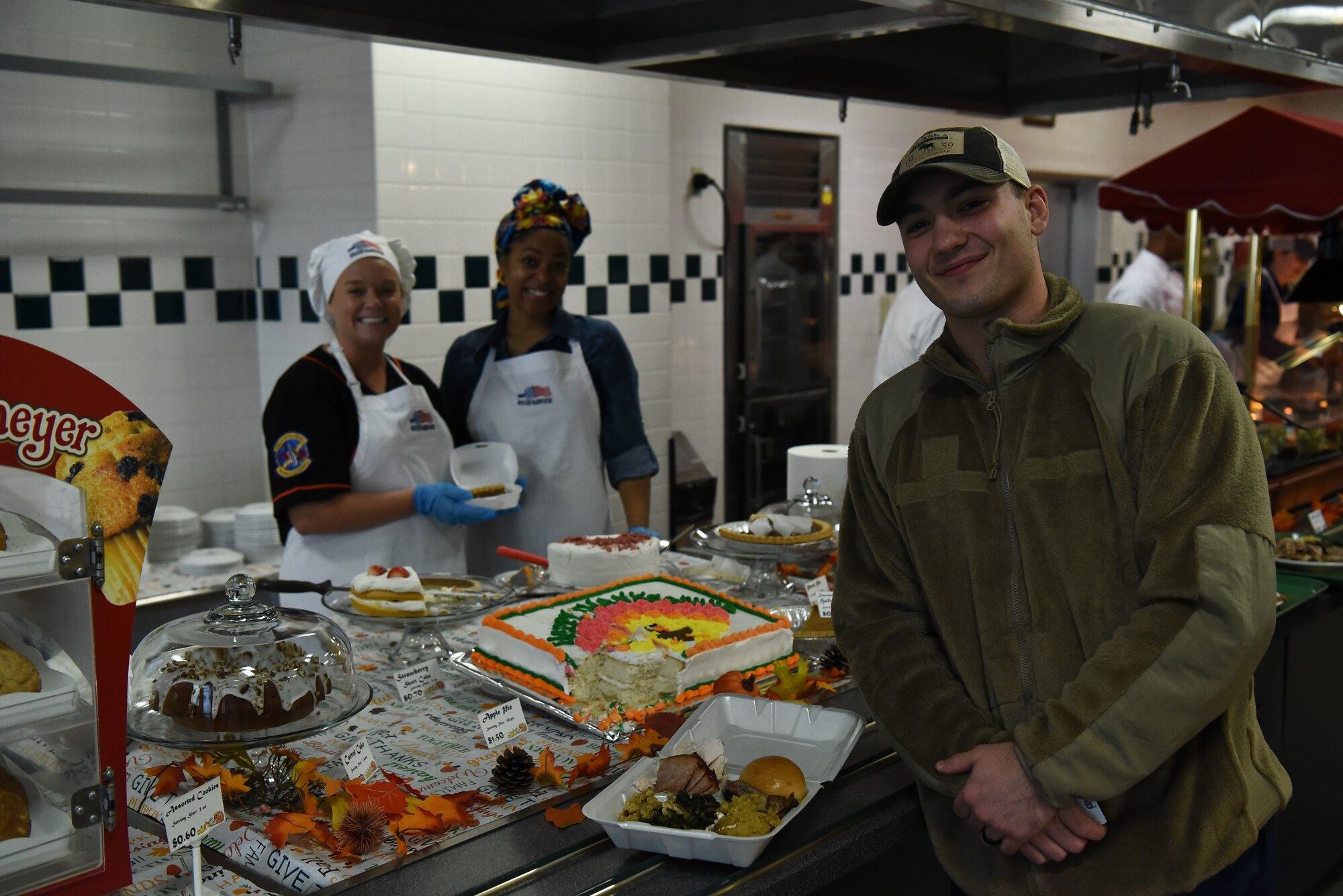 Young military member shows food received on Thanksgiving.