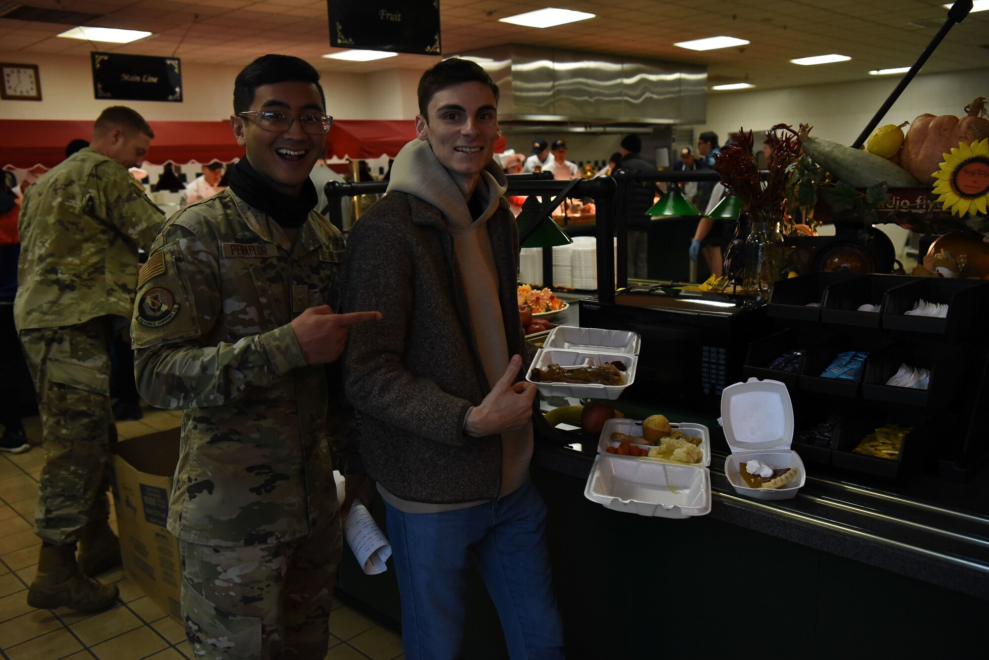 Military members show food received on Thanksgiving.